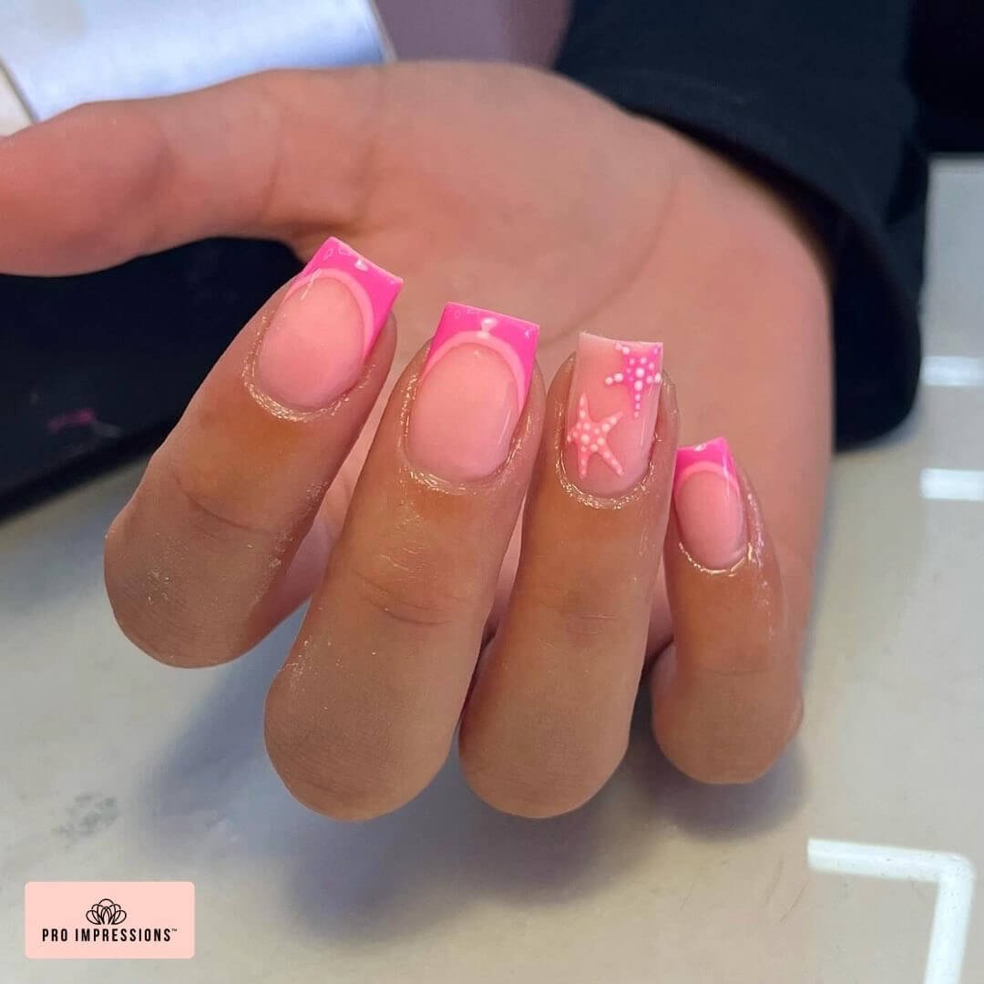 Square nails with neon pink French tips and starfish accents for a beachy summer vibe.