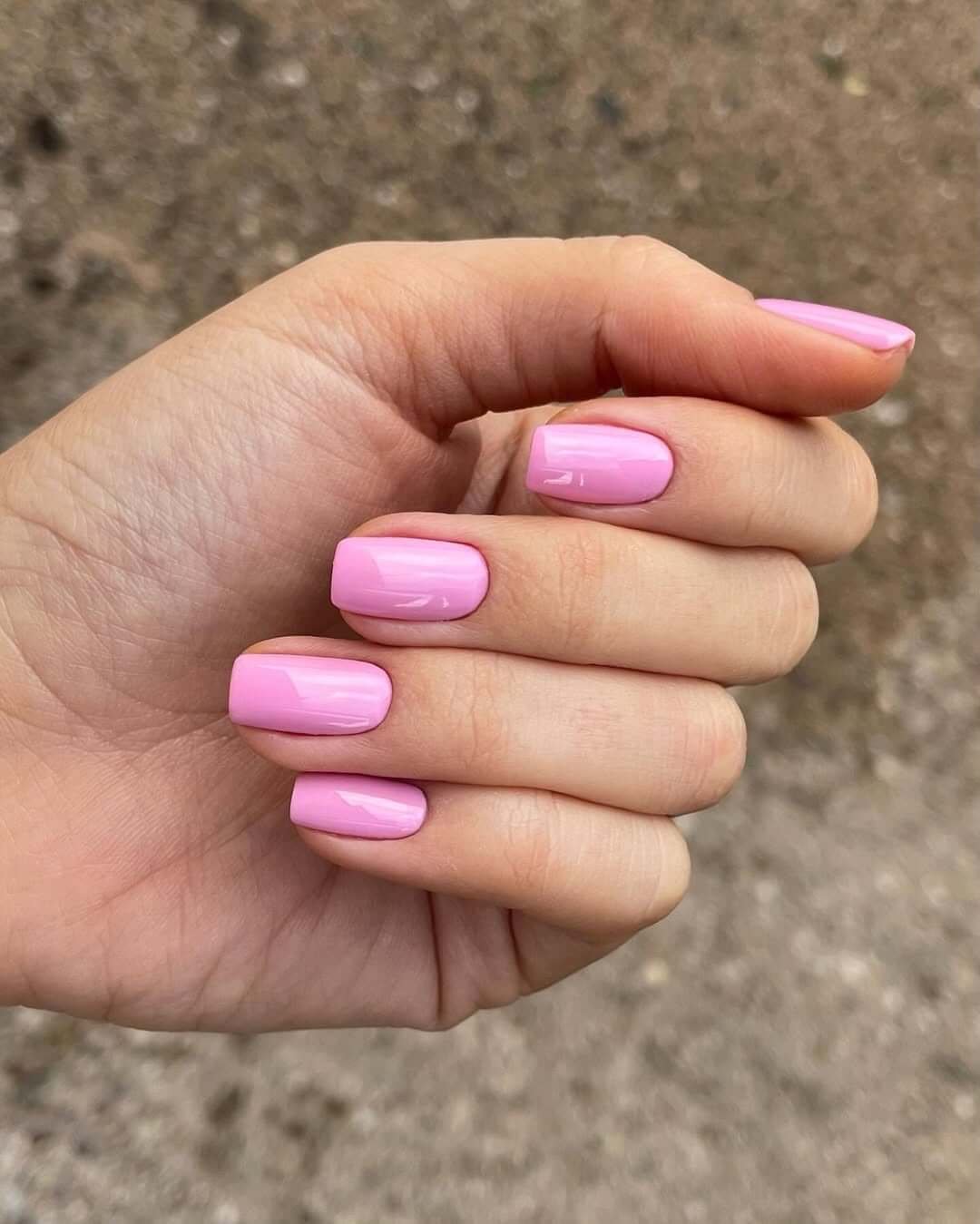 Short gel nails in glossy bubblegum pink for a clean, cheerful, and timeless mani.